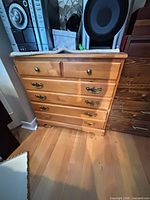 Light honey six-drawer dresser, brass-tone bail pulls