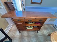 Full view of server with leaves extended showing drawers, shelving, casters