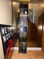 full view of tall shelving unit with decorative glassware