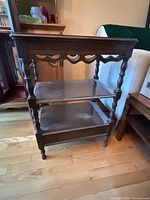 Full view of one side table showing design and shelves