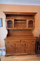Full view of wooden china cabinet showing hutch and sideboard details