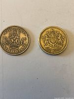 Obverse views of 1949 shilling and one-pound coins