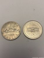 Reverse side of 1969 Voyageur and 1973 PEI dollar coins