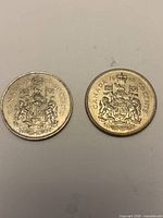 Reverse sides of both coins showing Canadian coat of arms with dates 1968 and 1981