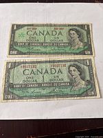 Fronts of both banknotes showing portraits, serials, centennial markings