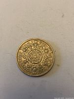 Reverse of 1957 UK two shillings coin showing floral design and date