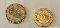 Obverse and reverse of 1957 shilling and 20p coin