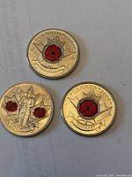 Three reverse sides showing red poppy design and dates 2004 (two) and 2010 (one).