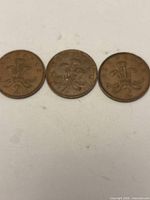 Three 2 New Pence coins reverse side showing Badge of Prince of Wales and "2" denomination