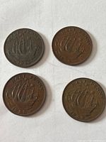 Obverse sides of four British half-penny coins dated 1948, 1958, 1959, 1959