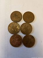 Six two-pence coins reverse side showing feathers design and dates