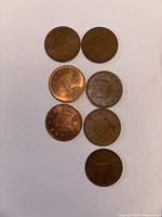 Seven UK one-penny coins reverse side showing portcullis design