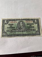 Obverse showing portrait, serial number 46611194, signatures, bilingual denomination