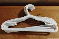 Stack of 20 white plastic children’s hangers