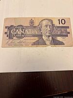 Obverse view showing Sir John A. Macdonald portrait, $10 numeral and CANADA text