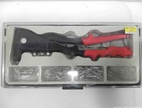 Closed clear plastic case showing riveter and rivets