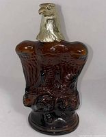 Front view of Avon American Eagle bottle showing molded eagle design and gold cap