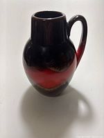 Frontal view of Scheurich fat lava vase showing red and black bands and handle