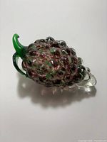 Full view of glass grape cluster showing color and stem