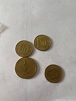 Four Israeli coins showing denomination sides