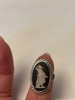 Front view showing black jasperware cameo with white classical figure in silver bezel