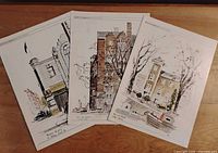 Group view of all three illustration pages laid out on table