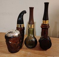 Front view of three Avon pipe-themed decanters