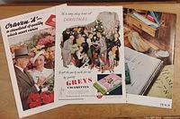 All three magazine advertisements laid out on table