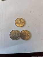 Reverse view showing crowned thistle design and denomination of three coins