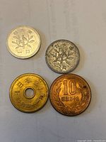 Obverse views of four Japanese coins showing denominations 1, 1, 5 with hole, 10