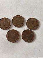 Reverse view of five 1⁄2 New Penny coins showing crown design