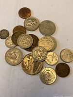 Group shot of mixed foreign coins in a pile