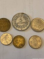 Obverse and reverse views of five of the coins including 5 F, 20 ct, Sower, cockerel and 1 F