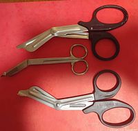 Group shot of all three medical scissors on red background