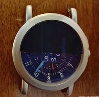 Front view showing half-covered blue dial and case