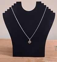 Full view of necklace on display showing chain length and pendant size