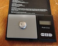 silver slug on digital pocket scale platform