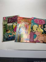 Three comic books laid out: Young Love, Sweethearts, Secret Hearts