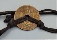 Obverse of 1943 British East Africa 10-cent coin on knotted brown cord