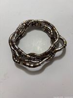 Chain coiled in multiple loops showing flexibility and coloration