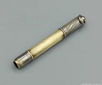 Pencil closed showing brass barrel and silver-tone cap