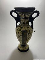 full front view of vase showing design and handles