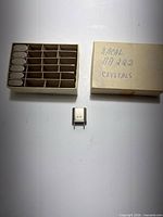 Box with six crystals and separate box lid, one crystal displayed front