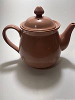 Full view of ceramic teapot with lid attached