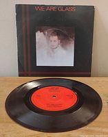 Front of picture sleeve with record displayed showing red label