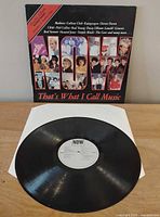 Front cover with artist montage and one vinyl record with white label