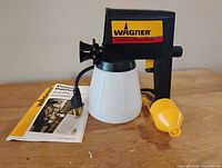 Sprayer assembled with paint cup, adapter and manual