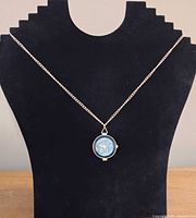 Pendant watch displayed on necklace stand