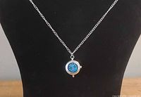 Pendant watch on display bust showing overall appearance and chain length