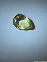 Front view of pear-cut lemon citrine showing table and crown facets